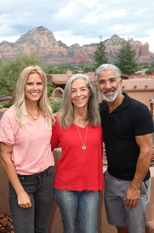 Striking portrait of a woman with curly hair, wearing a red jacket.